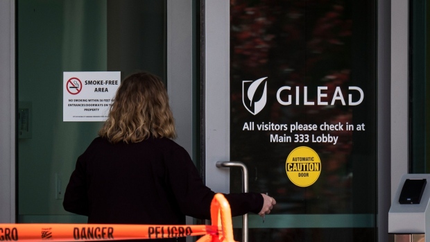 A person enters a building at Gilead Sciences Inc. headquarters in Foster City, California, U.S., on Thursday, March 19, 2020. Gilead Sciences stock jumped as much as 7% on Thursday, reaching a two-year high, as a Piper Sandler analyst doubled down on his call on the approval prospects for the biotech company's experimental therapy for the pandemic now sweeping the U.S. Photographer: David Paul Morris/Bloomberg