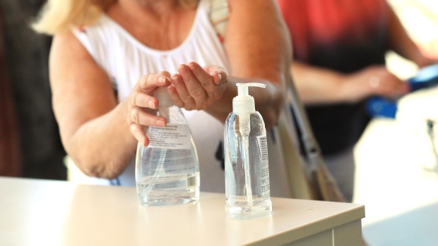 A customer uses hand sanitizer gel at the entrance of an Ikea AB store in Berlin, Germany, on Wednesday, May 20, 2020.