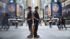 An NYPD officer wearing a protective mask stands in Times Square. Bloomberg/Angus Mordant