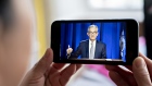 Jerome Powell, chairman of the U.S. Federal Reserve, speaks during a virtual news conference seen on a smartphone in Arlington, Virginia, U.S., on Wednesday, June 10, 2020. The Federal Reserve put a floor under its large-scale asset purchases and projected interest rates will remain near zero through at least 2022 as policy makers seek to speed the economy's recovery from the coronavirus recession.