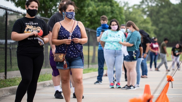 DALLAS, TX - JUNE 27: Patients wait in line at a walk up COVID-19 testing site at A+ Academy Secondary School on June 27, 2020 in Dallas, Texas. Texas is facing a surge of new cases of COVID-19 after the state government allowed business to open prematurely. (Photo by Montinique Monroe/Getty Images)