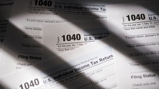 U.S. Department of the Treasury Internal Revenue Service (IRS) 1040 Individual Income Tax forms for the 2017 tax year are arranged for a photograph in Tiskilwa, Illinois, U.S., on Monday, March 19, 2018. The IRS urged taxpayers to use the Service's online tools to view the status of their federal tax account, information such as: the amount they owe or paying their tax liabilities online. Photographer: Daniel Acker/Bloomberg