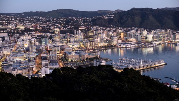 Buildings stand illuminated at dawn in Wellington, New Zealand, on Wednesday, July 18, 2018. New Zealand inflation picked up in the second quarter amid higher fuel and construction costs while the impact from a weaker currency was less than expected. Photographer: Birgit Krippner/Bloomberg