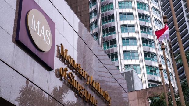 Signage for the Monetary Authority of Singapore (MAS) is displayed outside the central bank's headquarters in Singapore, on Tuesday, Oct. 22, 2019. Singapore's economy may be a few quarters away from a recovery as the decline in trade and manufacturing this year hasn't really spread to other sectors, the central bank's chief said.