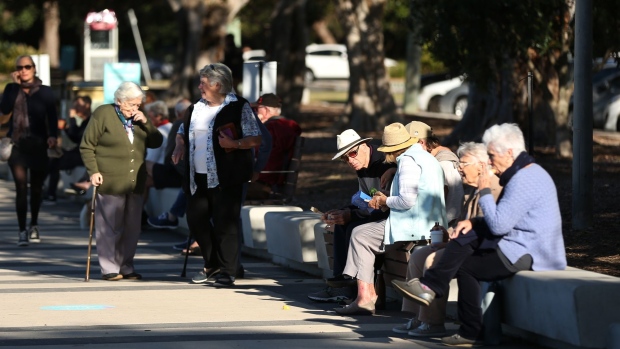People gather on benches along the promenade at Balmoral Beach during a partial lockdown imposed due to the coronavirus in the Mosman suburb of Sydney, Australia, on Tuesday, May 5, 2020. Australia’s central bank kept the interest rate and yield objective unchanged as it braces for the shock from the shuttering of large parts of the economy to stem the spread of the coronavirus.