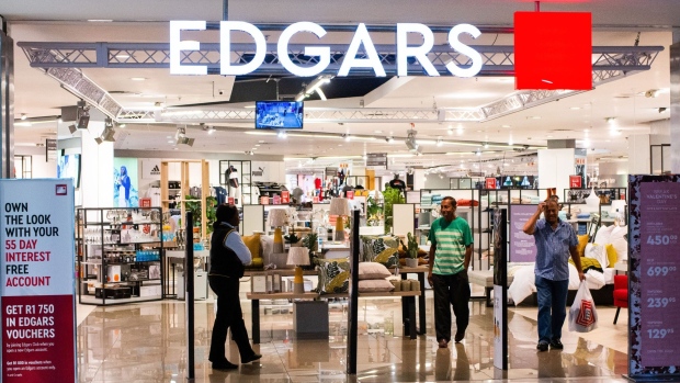 Shoppers exit an Edgars fashion and homeware store, operated by Edcon Holdings Ltd., in Johannesburg, South Africa, on Monday, Feb. 4, 2019. Edcon Holdings is making progress toward securing 3 billion rand ($226 million) in funding to keep the South African clothing retailer afloat, with the Public Investment Corp. part of the ongoing talks.