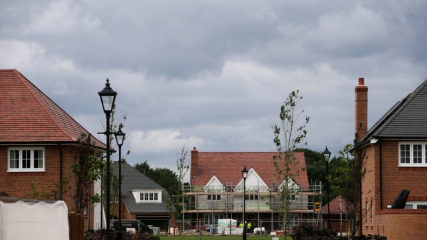 Scaffolding surrounds a house being built at the Woodford Garden Village residential property construction site in Greater Manchester, U.K., on Tuesday, July 4, 2017. U.K. house prices rebounded in June, halting the worst streak for the market in eight years, according to Nationwide Building Society.