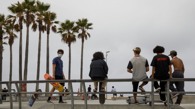 A skateboarder wearing a protective mask at the Venice Beach skate park in Los Angeles. Photographer: Patrick T. Fallon/Bloomberg