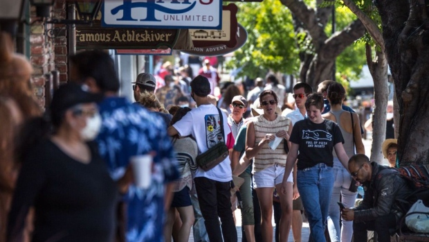 SOLVANG, CA - JUNE 13: A crowd of people, some wearing face masks, walk through the streets of Solvang as boutique shops, tasting rooms, hotels, and restaurants reopen to visitors on June 13, 2020, in Solvang, California. Because of its close proximity to Southern California and Los Angeles population centers, this Danish-themed tourist attraction in Santa Barbara County has become a popular weekend travel getaway destination for millions of tourists each year. (Photo by George Rose/Getty Images)