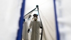 A doctor wearing protective gear goes through an air tight curtain while entering the Covid-19 intensive care unit (ICU) at the United Memorial Medical Center (UMMC) in Houston, Texas, U.S., on Monday, June 29, 2020. Covid-19 cases and hospitalizations have spiked since Texas reopened eight weeks ago, pushing intensive-care wards to full capacity and sparking concerns about a surge in fatalities as the contagion spreads.