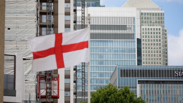 An English national flag flies in the Canary Wharf financial, shopping business district in London on June 29. Photographer: Jason Alden/Bloomberg
