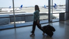 A traveler walks past United Airlines Holdings Inc. airplanes parked at Newark International Airport (EWR) in Newark, New Jersey, U.S., on Tuesday, June 9, 2020. Airline losses are surging to unprecedented levels expected to be more than three times those following the 2008 global economic slump, according to the industry's main trade group.