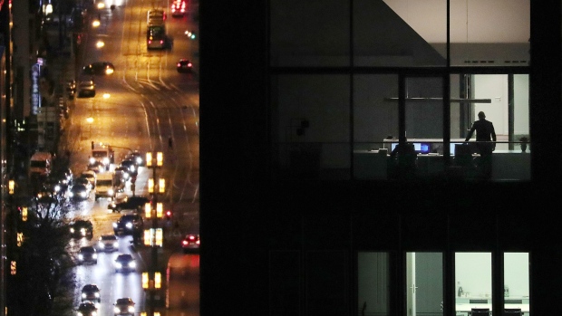 Bloomberg Best of the Year 2019: Workers stand in an illuminated office building at night as automobiles pass below in the financial district in Frankfurt, Germany, on Thursday, Jan. 31, 2019. Photographer: Krisztian Bocsi/Bloomberg