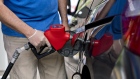 A customer wears a protective glove while refueling a vehicle at an Exxon Mobil Corp. gas station in Arlington, Virginia, U.S., on Wednesday, April 29, 2020. Exxon is scheduled to released earnings figures on May 1.