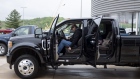 A customer adjusts the drivers seat as he prepares to leave with his new 2020 Ford Motor Co. F-450 truck at a car dealership in Peoria, Illinois, U.S., on Thursday, May 14, 2020. With losses mounting and North American factories idle in the face of coronavirus shutdowns, Ford shareholders gathered for their virtual annual meeting Thursday.