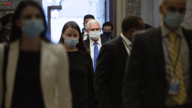 Vice President Mike Pence, center, wears a protective mask while arriving at the U.S. Capitol in Washington, D.C., U.S., on Tuesday, May 19, 2020. Lawmakers will receive an update today on implementation of the $2.2 trillion virus rescue package passed by Congress in March. Photographer: Stefani Reynolds/Bloomberg