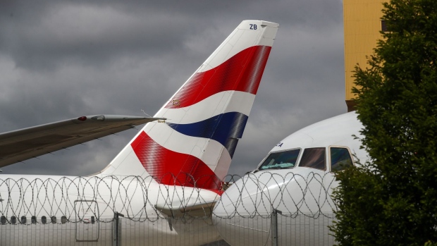 British Airways livery sits on the tail-fin of a passenger aircraft, operated by British Airways, a unit of International Consolidated Airlines Group SA (IAG) grounded at London Heathrow Airport in London, U.K., on Monday, June 8, 2020. The U.K. is pressing ahead with a two-week quarantine on international arrivals, a move British Airways and other carriers say will devastate tourism and wreck any chance the summer holiday season could spark a recovery from a virus-induced slump. Photographer: Simon Dawson/Bloomberg