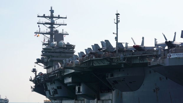 The USS Ronald Reagan, a Nimitz-class aircraft carrier and part of the U.S Navy 7th Fleet, sits anchored in Hong Kong, China, on Wednesday, Nov. 21, 2018. A trio of U.S. naval vessels anchored in Hong Kong on Wednesday, the first U.S. naval ships to harbor in the city since China barred entry to another American ship in September, in a sign of easing military tensions between the two powers. Photographer: Anthony Kwan/Bloomberg