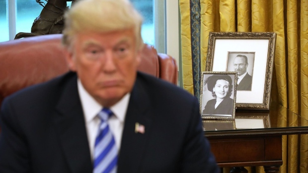 ramed photographs of President Donald Trump's parents, Fred and Mary Trump, sit on a table in the Oval Office.