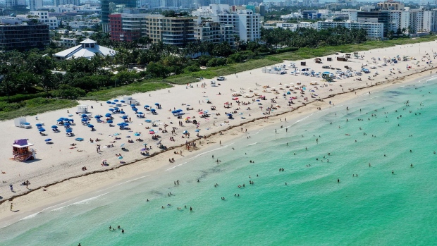 An aerial drone view as beachgoers take advantage of the opening of South Beach on June 10, 2020 in Miami Beach, Florida.