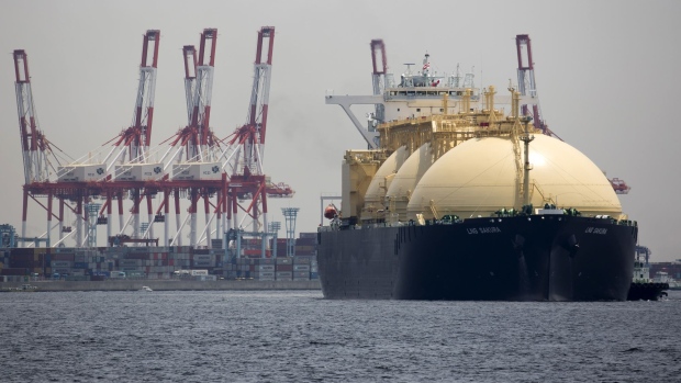 The LNG Sakura liquefied natural gas tanker sails past a container terminal as it arrives at Tokyo Gas Co.'s Negishi LNG terminal in Yokohama, Japan, on Monday, May 21, 2018. Tokyo Gas received Japan's first LNG shipment from Dominion Energy's Cove Point project today, the company said in statement. Photographer: Tomohiro Ohsumi/Bloomberg