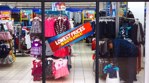 An employee stocks display hangars with children's clothing inside a PEP retail store, operated by Pepkor, a unit of Steinhoff International Holdings NV, in Johannesburg, South Africa, on Thursday, Aug. 31, 2017. Steinhoff said like-for-like sales rose 8 percent as the South African furniture and clothing retailer achieved gains in its core European and African markets.