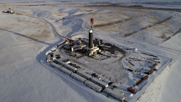 A Unit Drilling Co. rig stands in the Bakken Formation in this aerial photograph outside Watford City, North Dakota, U.S., on Friday, March 9, 2018. When oil sold for $100 a barrel, many oil towns dotting the nation's shale basins grew faster than its infrastructure and services could handle. Since 2015, as oil prices floundered, Williston has added new roads, including a truck route around the city, two new fire stations, expanded the landfill, opened a new waste water treatment plant and started work on an airport relocation and expansion project. Photographer: Daniel Acker/Bloomberg