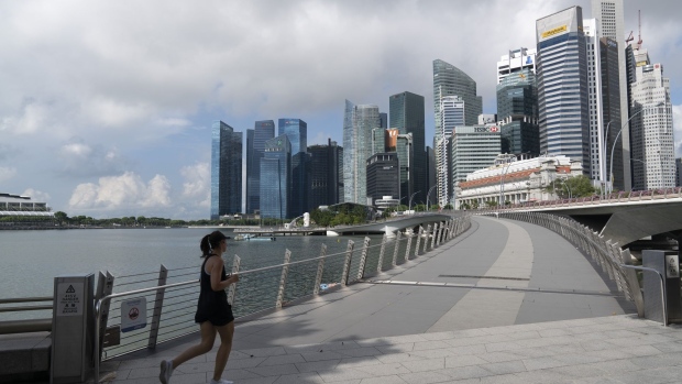 A jogger runs toward the Central Business District in Singapore on Monday, July 6, 2020. Prime Minister Lee Hsien Loong vowed to hand over Singapore “intact” and in “good working order” to the next generation of leaders, predicting the coronavirus crisis will “weigh heavily” on the nation’s economy for at least a year.