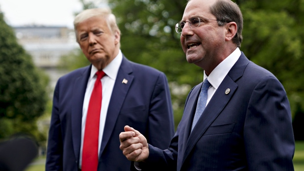 Alex Azar, secretary of Health and Human Services (HHS), speaks to members of the media as U.S. President Donald Trump, left, listens before boarding Marine One on the South Lawn of the White House in Washington, D.C., U.S., on Thursday, May 14, 2020. Trump is visiting the factory of Owens and Minor, a medical equipment distributor, in Allentown, Pennsylvania.
