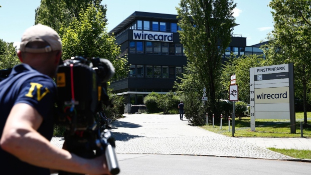 A television news camera operator films outside the Wirecard headquarters during a police and prosecutors raid in Munich, Germany. Photographer: Michaela Handrek-Rehle/Bloomberg