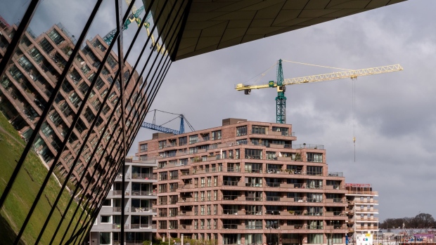 A construction crane stands beyond a new residential apartment block near the Eye Museum in Amsterdam, Netherlands, on Monday, March 25, 2019. Amsterdam is the latest European city to try to get a grip on its buy-to-let housing market as it seeks to stop a wave of landlords from capitalizing on booming property prices.
