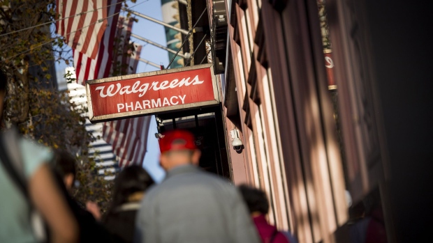 Pedestrians pass in front of a Walgreens store in San Francisco. Photographer: David Paul Morris/Bloomberg
