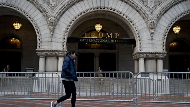 A pedestrian walks past the Trump International Hotel in Washington, D.C, U.S., on Thursday, April 23, 2020. Although the Trump family business was explicitly prohibited from benefiting from federal aid authorized in the last few weeks by Congress, its hotel in Washington is seeking separate relief on $3 million of annual rent that it pays to the U.S. General Services Administration the New York Times reported this week.