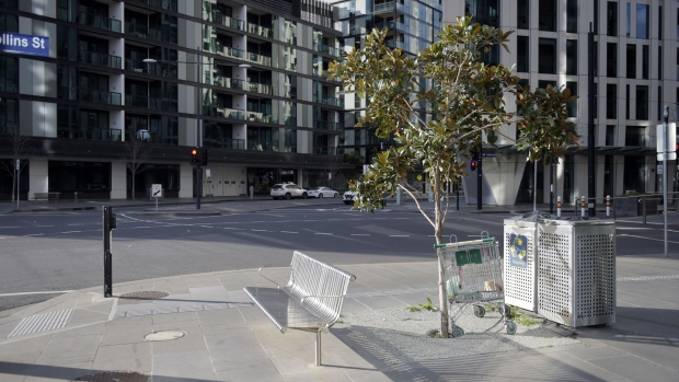 A shopping cart is left abandoned on a deserted street in the Docklands area of Melbourne, Australia, on Thursday, July 9, 2020. The six-week stay-at-home order that came into force across the Victoria state capital is set to devastate the city's restaurants, cafes, beauty spas and small retailers, which were just taking their first tentative steps back to business-as-usual. Melbourne's travails also provide a cautionary tale for other big, service economy-driven cities such as London, that are reopening pubs and restaurants in a bid to jump-start their crippled economies.