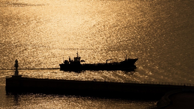 A ship sails past the lighthouse at sunset in the Port of Incheon in Incheon, South Korea, on Monday, Sept. 4, 2017. President Donald Trump said he would discuss the future of the U.S.-South Korea free-trade agreement with his advisers following a newspaper report that hes considering terminating the pact. Photographer: Bloomberg/Bloomberg