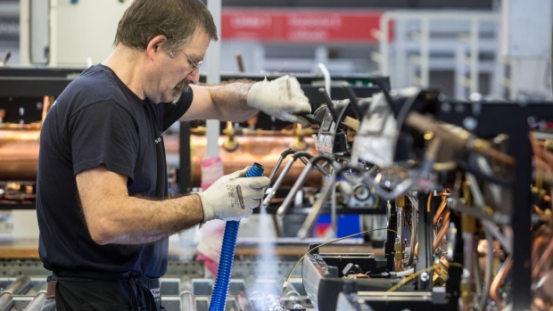 An employee works on the coffee machine production line at the Nuova Simonelli SpA factory in Tolentino, Italy, on Monday, June 11, 2018. In the vote on March 4, support for the anti-immigrant League surged massively in Macerata, helping to propel the party into government this month. Photographer: Giulio Napolitano/Bloomberg