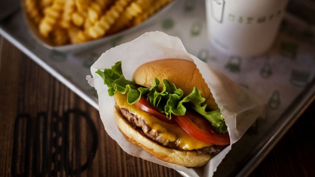 A burger, fries, and beverage are arranged for a photograph at a Shake Shack restaurant in New York, U.S., on Wednesday, Sept. 10, 2014. Shake Shack, the burger chain started by restauranteur Danny Meyer as a kiosk in a New York City park, is preparing for an initial public offering that could value it as high as $1 billion, people familiar with the matter said.