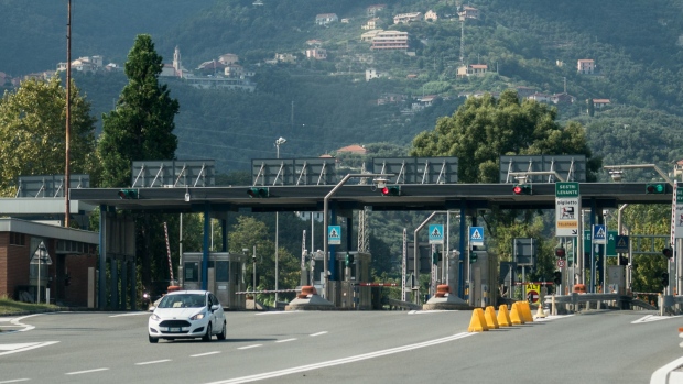 A vehicle exits a toll booth on the A12 Highway operated by Autostrade near Genoa, Italy. Photographer: Federico Bernini/Bloomberg