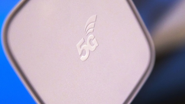 A 5G logo sits on top of a Huawei Technologies Co. 5G CPE (customer-premises equipment) Pro 2 router unit on display during a 5G event in London, U.K., on Thursday, Feb. 20, 2020. Huawei said at the event it currently has 91 contracts for 5G, with 47 of those in Europe. Photographer: Chris Ratcliffe/Bloomberg