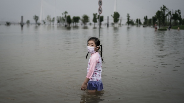 A girl plays in a flooded park in Wuhan on July 10.