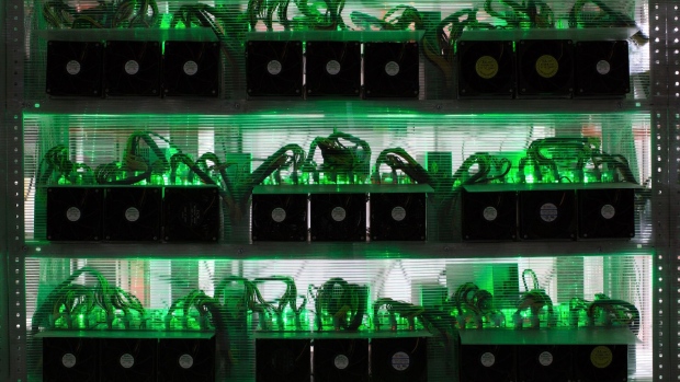 Lights illuminate as application-specific integrated circuit (ASIC) devices and power units operate inside a rack at the BitRiver Rus LLC cryptocurrency mining farm in Bratsk, Russia, on Friday, Nov. 8, 2019. Bitriver, the largest data center in the former Soviet Union, was opened just a year ago, but has already won clients from all over the world, including the U.S., Japan and China. Most of them mine bitcoins. Photographer: Andrey Rudakov/Bloomberg