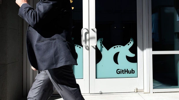 A pedestrian walks past the GitHub Inc. offices in San Francisco, California, U.S., on Monday, June 4, 2018. Microsoft Corp. is buying GitHub for $7.5 billion in stock, bringing in house a community of 28 million programmers who publish code openly and extending a shift away from a strategy of shrouding its software in secrecy.