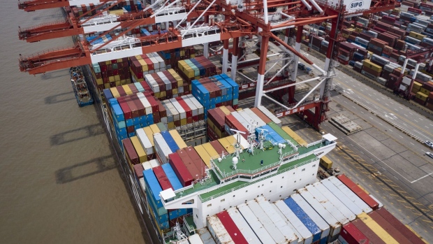 A vessel loaded with shipping containers is docked at the Yangshan Deepwater Port in this aerial photograph taken in Shanghai, China, on Sunday, July 12, 2020. U.S. President Donald Trump said Friday a phase two trade deal with China isn't under consideration, saying the relationship between Washington and Beijing has deteriorated too much.