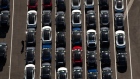 Vehicles sit parked outside of the Tesla Inc. assembly plant in this aerial photograph taken above Fremont, California, U.S., on Wednesday, Oct. 23, 2019. Tesla shares are trading above Wall Street expectations after spending most of the year languishing below analysts' average price targets. Photographer: Sam Hall/Bloomberg