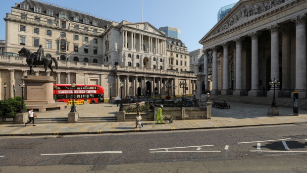 Pedestrians pass the Bank of England (BOE) in the City of London, U.K., on Wednesday, June 24, 2020. Getting people back into stores after a 12-week pause is crucial for Britain's 400 billion-pound ($502 billion) retail industry, and for the country at large, which relies on consumer spending for about 60% of gross domestic product. Photographer: Simon Dawson/Bloomberg