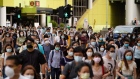 Pedestrians wearing protective masks walk across a road in Hong Kong, China, on Friday, July 10, 2020.