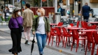 Pedestrians wearing protective face mask pass a cafe near the Natural History and Victoria and Albert Museums in London, U.K., on Thursday, July 9, 2020. The U.K. will plow 1.6 billion pounds ($2 billion) into theaters, museums and music venues in a bid to rescue the country's arts and culture sector from the brink of collapse in the wake of the coronavirus lockdown.