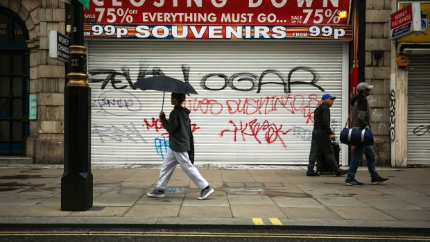 Pedestrians pass a closed and shuttered souvenir shop on Oxford Street in London, U.K., on Thursday, July 9, 2020. British shops aren't getting much of a boost from newly reopened bars, cafes and restaurants as customers prefer to stay away. Photographer: Simon Dawson/Bloomberg