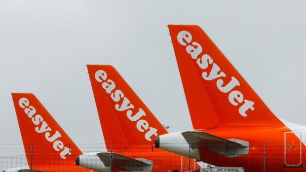 Passenger aircraft, operated EasyJet Plc, sit grounded on the tarmac at London Stansted Airport, operated by Manchester Airport Plc, in Stansted, U.K., on Thursday, July 9, 2020. EasyJet Plc is considering cutting a third of its pilot positions and may eliminate three bases in the U.K., including London's Stansted airport, in reaction to a business slump that the discount carrier doesn’t expect to rebound for another three years.