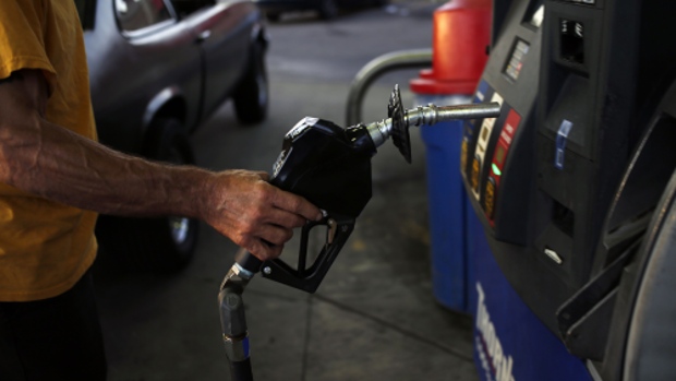 A customer refuels a vehicle at a Thornton's Inc. gas station in New Albany, Indiana, U.S., on Thursday, June 27, 2019. The national average for unleaded fuel is $2.72 a gallon, down 15 cents from last year's Fourth of July holiday. The lower prices are motivating a record number to hit the road, with 41.4 million commuters expected to travel by automobile, according to AAA.